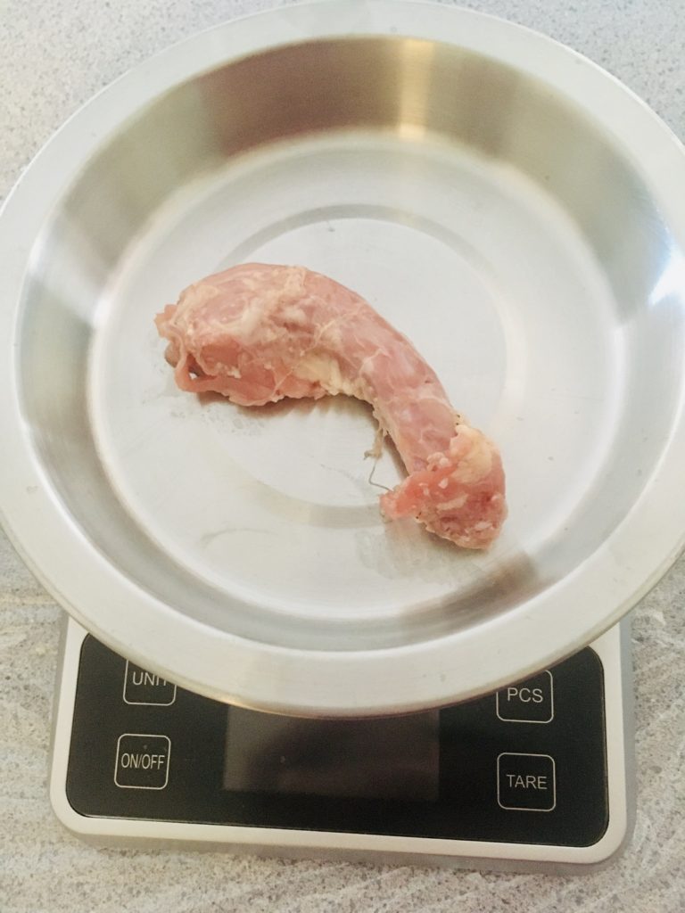 raw chicken neck on digital scale